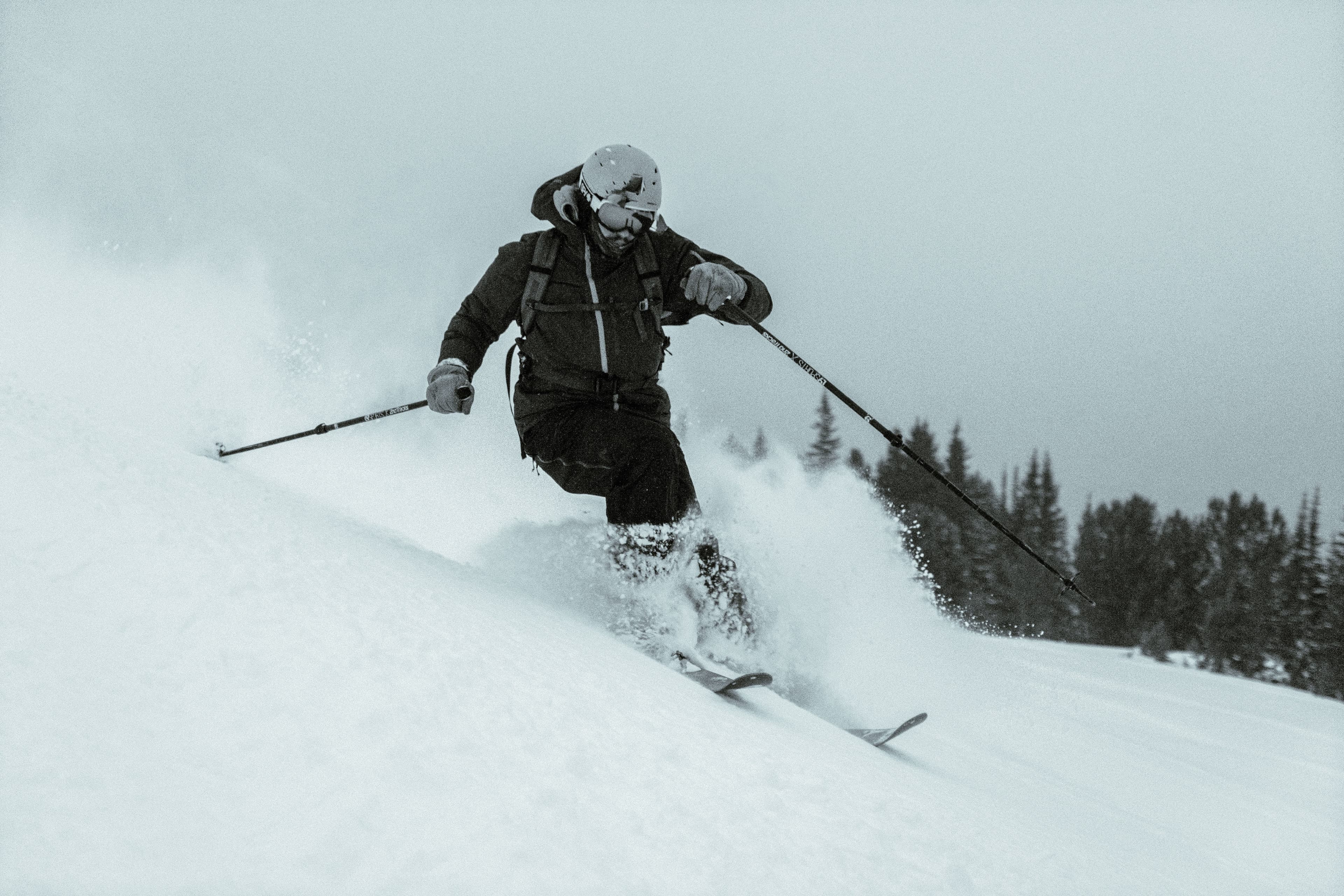 A skier skiing through a storm day near the Roost.